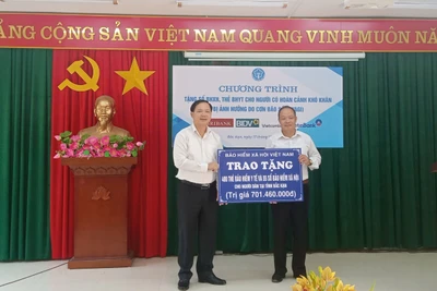 Phó Tổng Giám đốc BHXH Việt Nam, Chu Mạnh Sinh trao biển tượng trưng số tiền tặng sổ, thẻ cho đại diện UBND thành phố Bắc Kạn