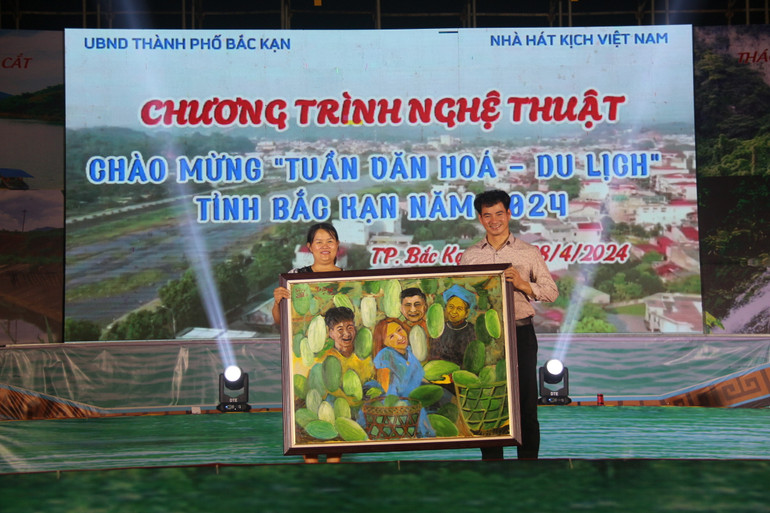 Chị Nông Thị Tô Hường, Hội viên Hội VHNT tỉnh trao tặng bức tranh "Mùa bí xanh Ba Bể" cho Nghệ sĩ Nhân dân Xuân Bắc. IMG_9852.JPG