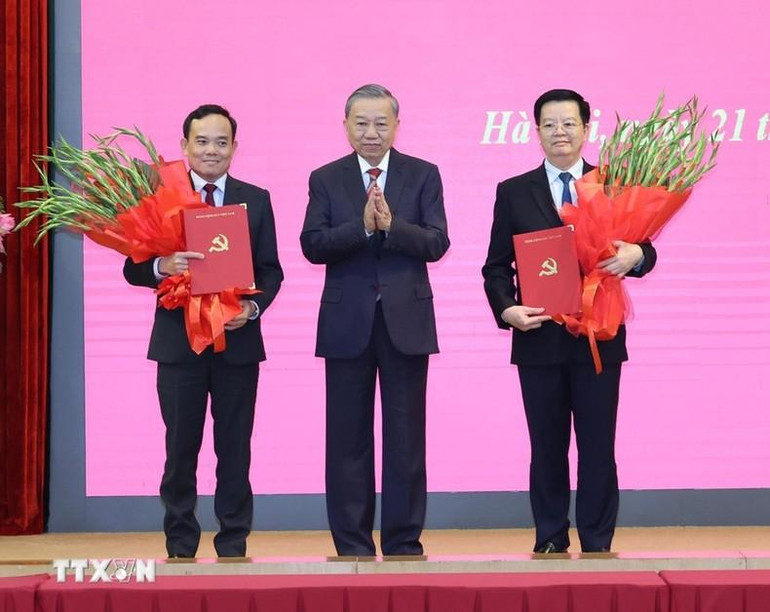 Tổng Bí thư, Chủ tịch nước Tô Lâm trao Quyết định phân công nhiệm vụ của Bộ Chính trị và tặng hoa chúc mừng các đồng chí Trần Lưu Quang (bên trái), Trưởng Ban Kinh tế Trung ương và Mai Văn Chính (bên phải), Trưởng Ban Dân vận Trung ương. (Ảnh: Trí Dũng/TTXVN) Tổng Bí thư, Chủ tịch nước Tô Lâm trao Quyết định phân công nhiệm vụ của Bộ Chính trị và tặng hoa chúc mừng các đồng chí Trần Lưu Quang (bên trái), Trưởng Ban Kinh tế Trung ương và Mai Văn Chính (bên phải), Trưởng Ban Dân vận Trung ương. (Ảnh: Trí Dũng/TTXVN)