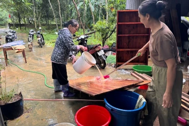 Người dân thị trấn Đồng Tâm (Chợ Mới) dọn dẹp nhà cửa, vệ sinh môi trường sau lũ lụt