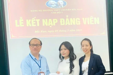 Thầy giáo Lê Xuân Thứ, Bí thư Đảng bộ, Hiệu trưởng Trường THPT Chuyên Bắc Kạn và cô giáo Lã Thị Lệ Hà, Bí thư Chi bộ 1, Trường THPT Chuyên Bắc Kạn trao Quyết định kết nạp cho đảng viên mới Trần Thị Quỳnh Hương.